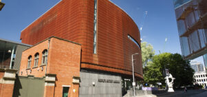 The Corten exterior of People’s History Museum on a sunny day beneath blue skies