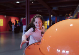 A young girl playing in the Experiment gallery at the Science and Industry Museum