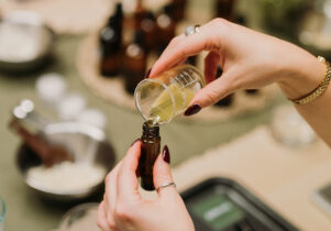 An image of someone pouring oils into an aromatherapy roll on bottle.