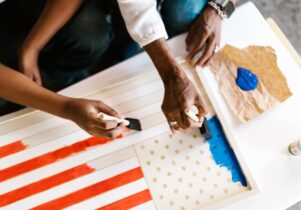 hands painting a flag