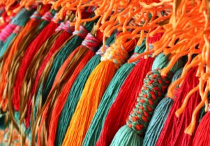 Large jewel coloured handmade tassels in shades of turquoise, red and orange