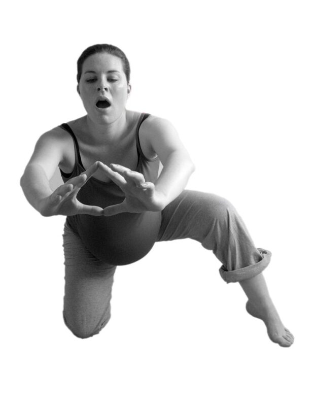 A photograph of a pregnant woman in a yoga pose.