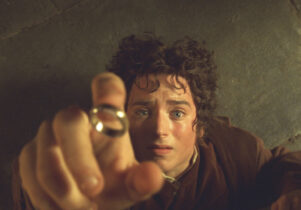 Frodo leans back to catch the ring on his finger