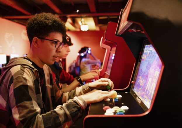 Boy playing retro arcade games in Power Up.