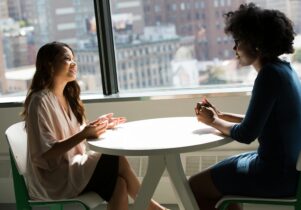 Two women chatting at a table