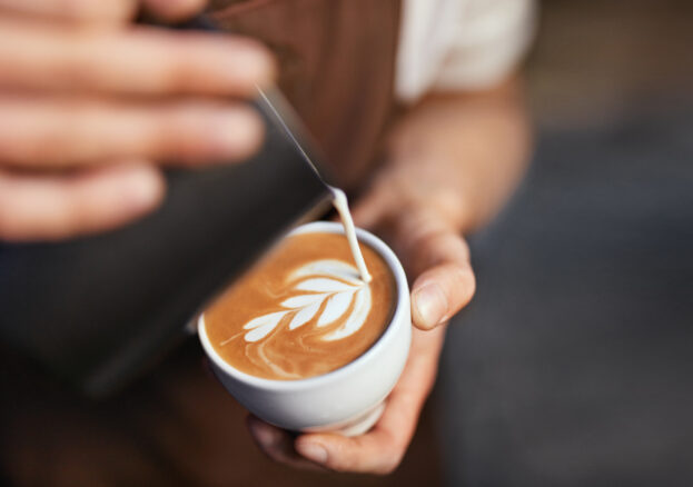 Coffee Art In Cup. Closeup Of Barista Hands Making Latte Art Picture With Milk On Coffee. High Resolution