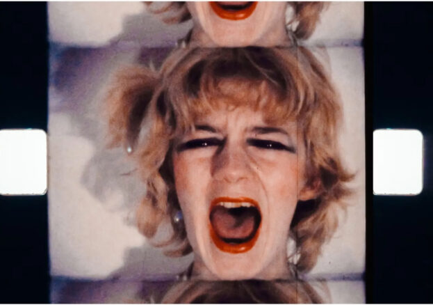 A film still, showing a woman's face screaming.