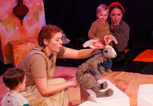 Children watching a show with puppets. Persephone at Leeds Playhouse