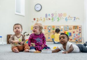 Three babies playing together in a Sure Start Manchester's baby week