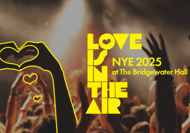 A crowd holding up their hands in heart shapes, with the words LOVE IS IN THE AIR overlaid in yellow.