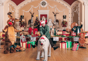 Person with Santa hat sitting on polar bear on center foreground, with chaotic Christmas decorations in the background