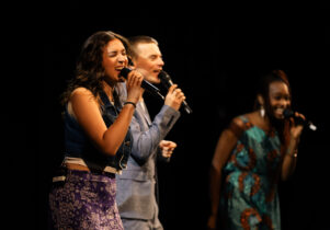 Singers on stage with microphone